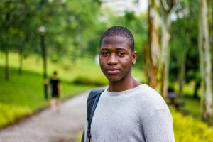 selective focus photography of man in gray crew-neck shirt black student